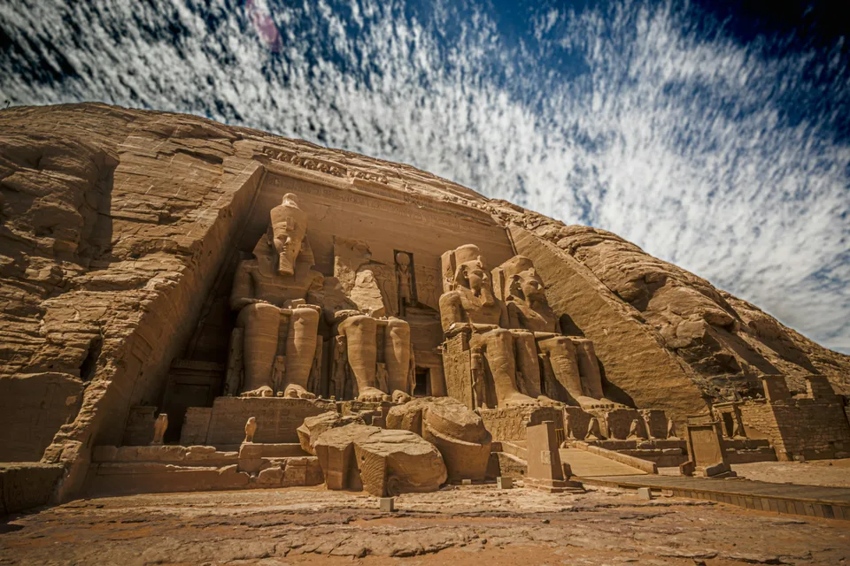 The rock-cut facade of Abu Simbel under a textured sky