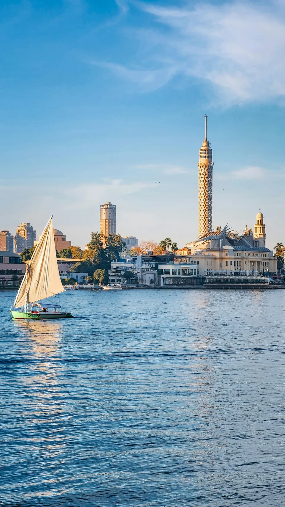 A sailing boat on the Nile beside the Cairo skyline