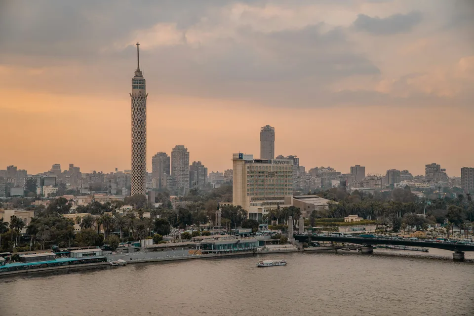 Cairo Tower and the riverside skyline under a warm evening sky