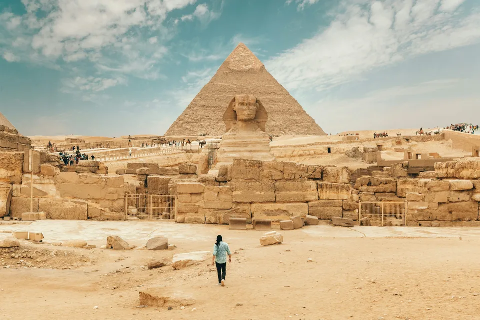 The Great Sphinx and pyramid with stone ruins in the foreground