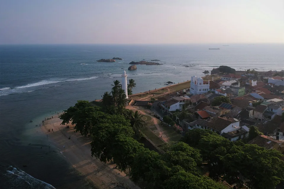 Galle lighthouse and coastal rooftops overlooking the ocean