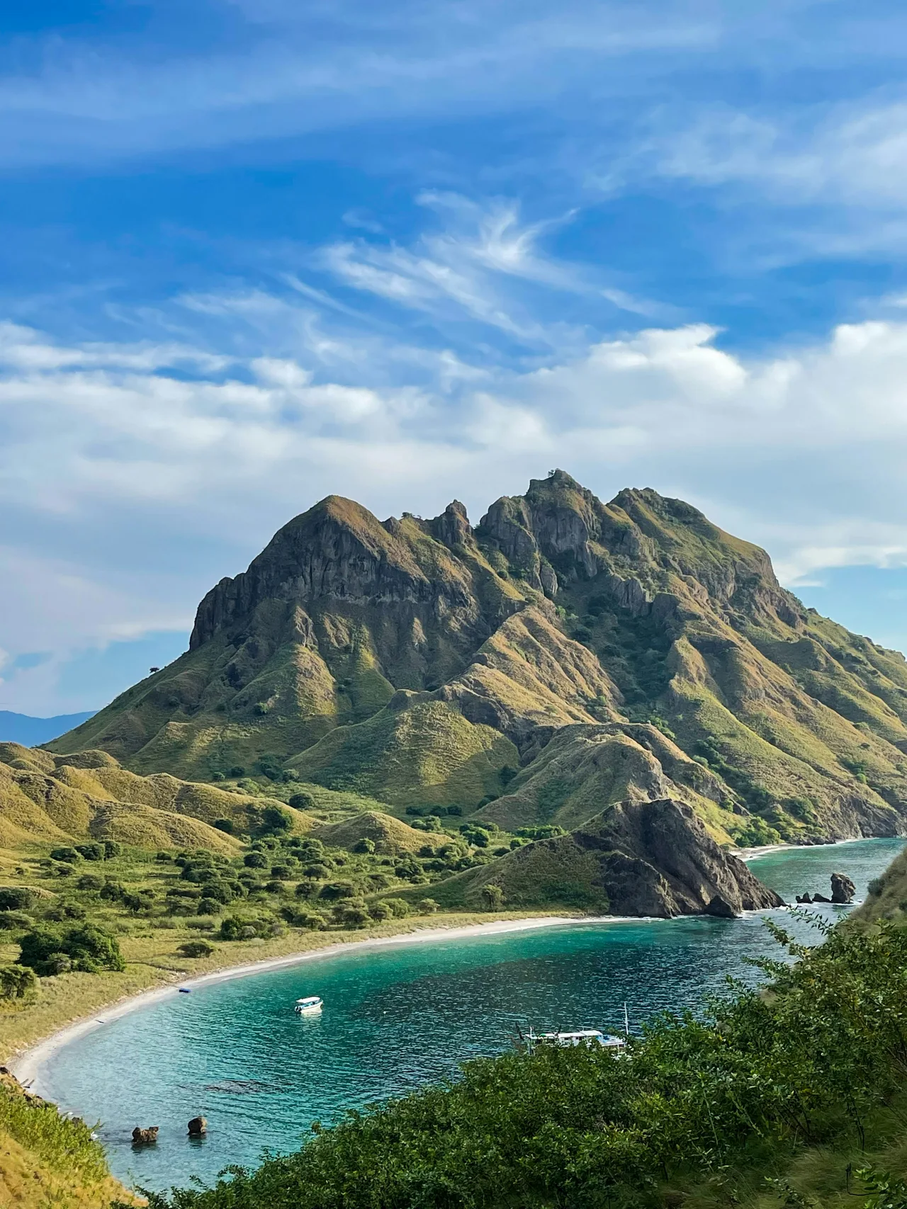 Green island mountains above a bright turquoise bay