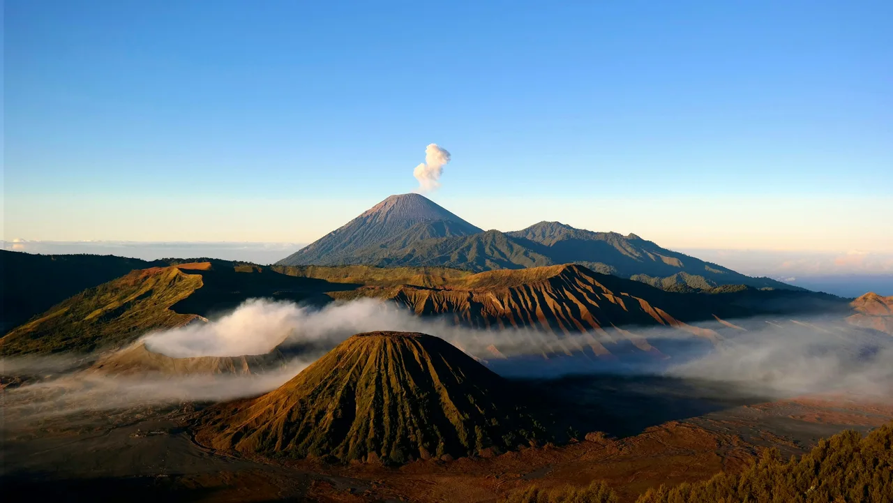 Volcanic peaks rising above a sea of clouds at Mount Bromo