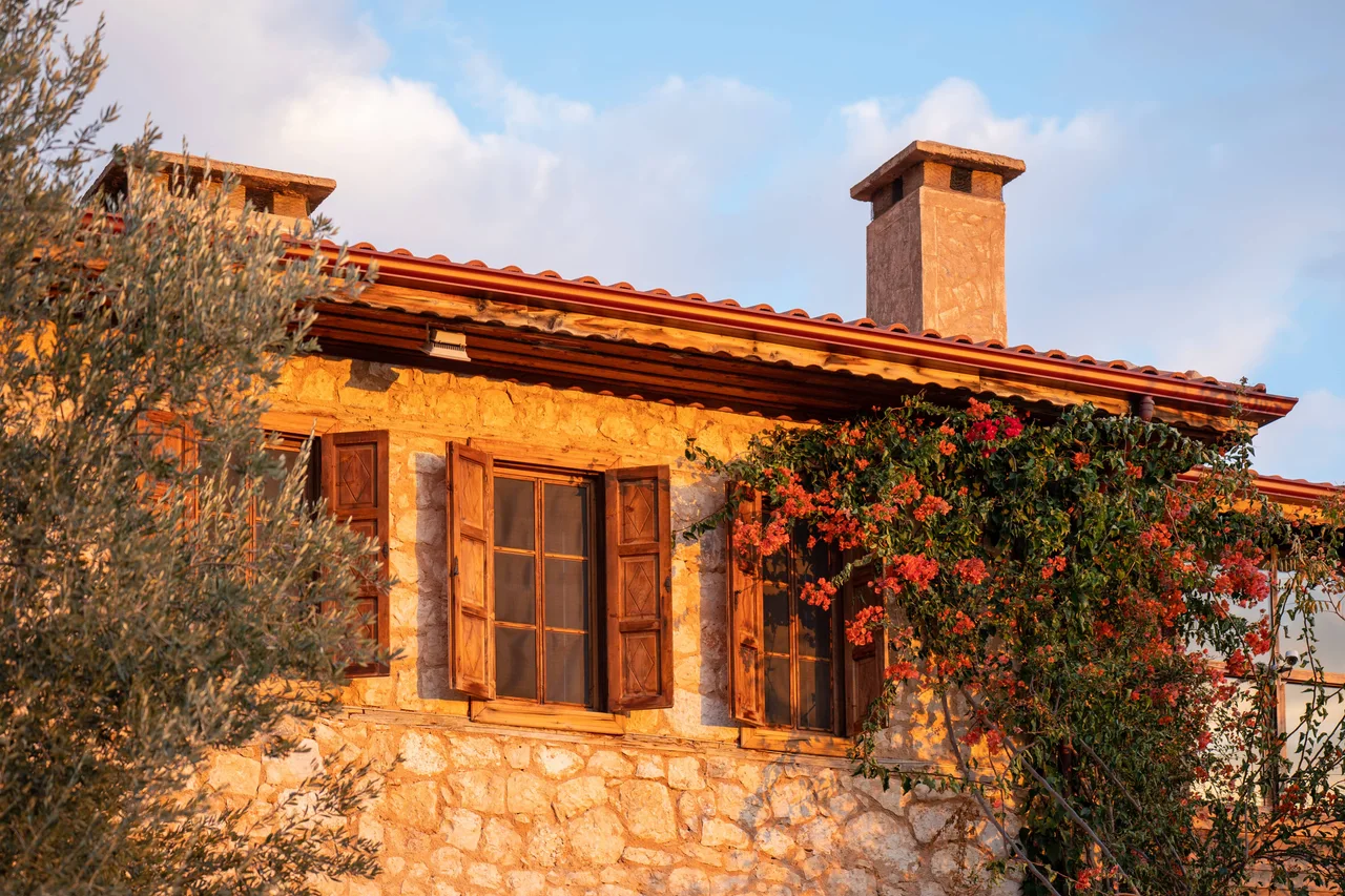 Traditional stone house with timber details in Beymelek