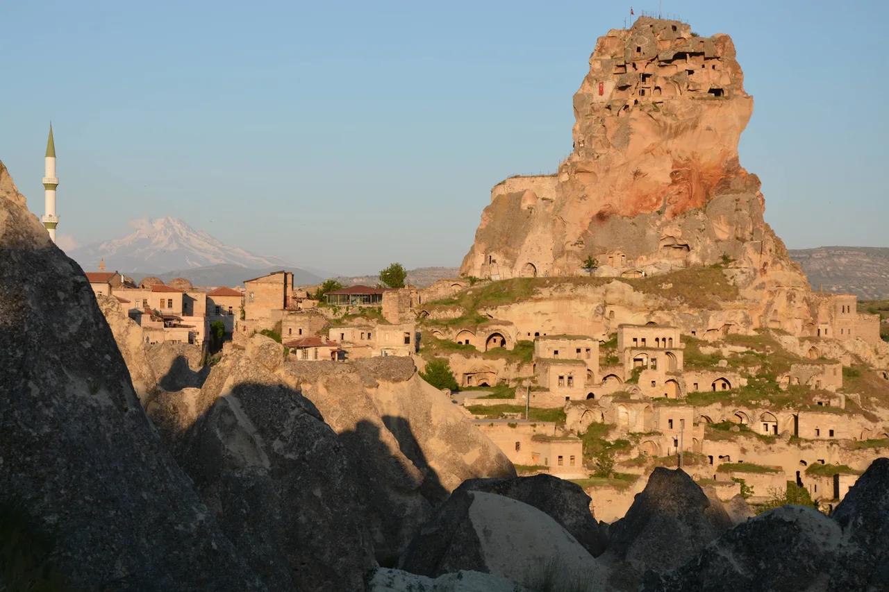 A Cappadocian town surrounding a towering rock castle