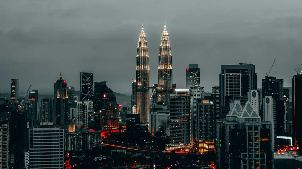 Petronas Twin Towers rising above the city at dusk