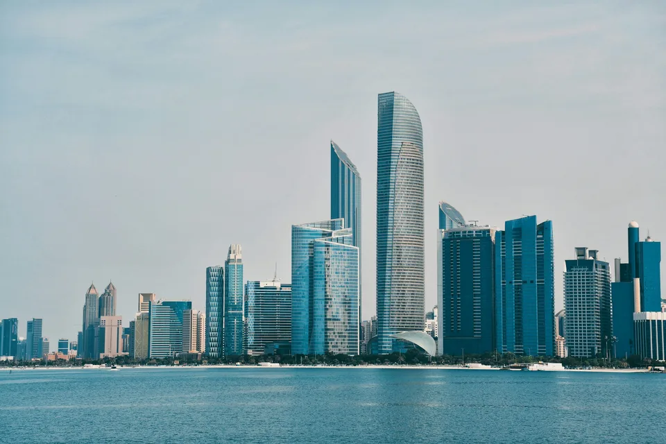 Modern towers across blue water in Abu Dhabi