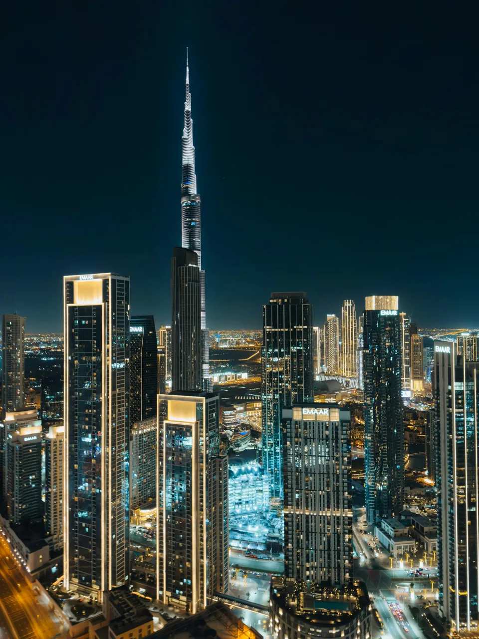 Illuminated Burj Khalifa towering over the Dubai skyline at night