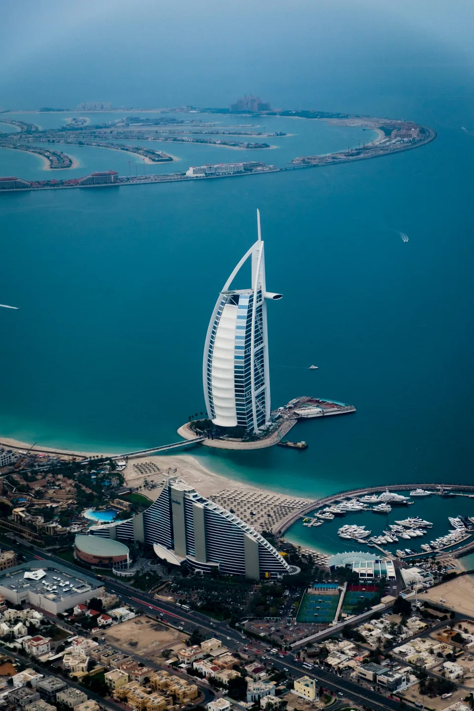 Burj Al Arab beside turquoise sea and beaches