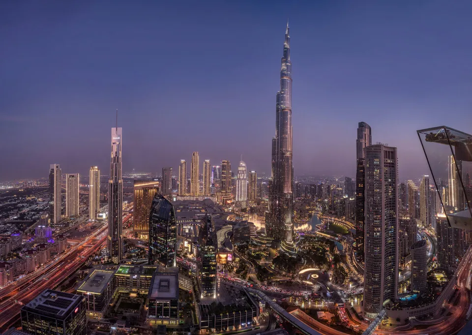 Burj Khalifa and surrounding towers lit up at blue hour
