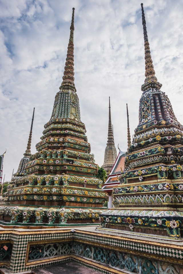 Tall ornate tiled chedis at Wat Pho in Bangkok